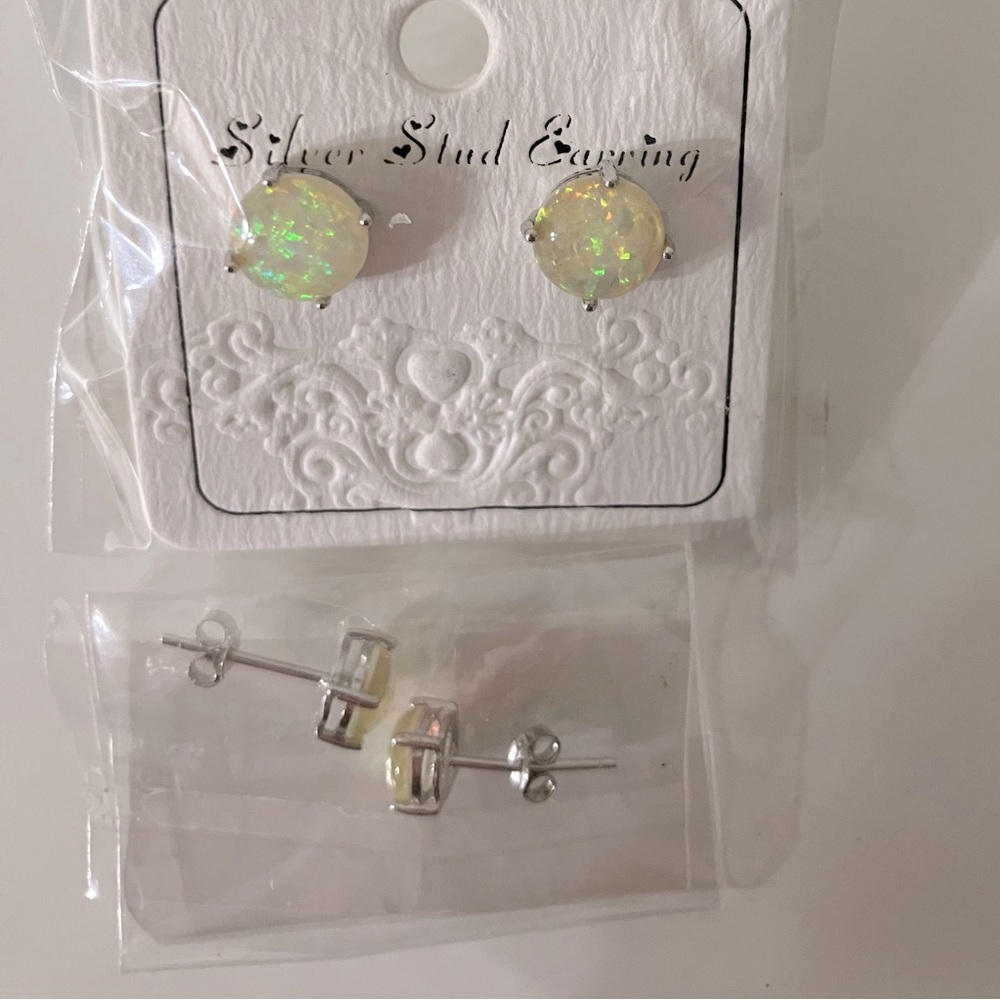 Two pair of gilttery, opal like stud earrings